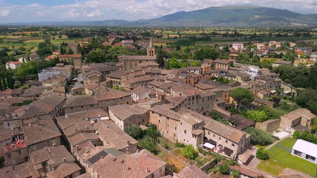 Bevagna Medieval Borgo Aerial Drone View Umbria Italy Authentic Historic Village Dense Stone Architecture Terracotta Roofs Scenic Green Landscape with Distant Mountains Stunning Cinematic 4K Video 