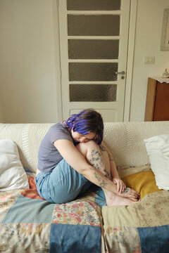 Portrait of a non-binary person feeling introspective in their home