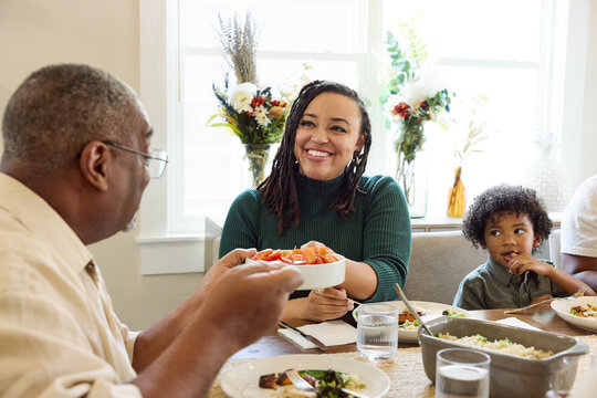 A Family Gathers at the Table for a Meal