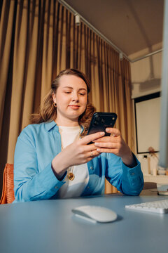 A woman uses a mobile phone in the office