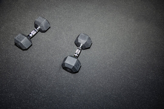 Gym dumbbells on rubber floor with flash