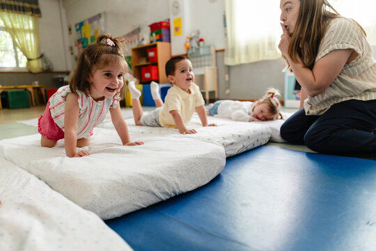 Happy children learning and developing motor skills in classroom