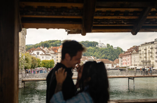 Blurred couple sharing intimate moment in Kapellbr&uuml;cke