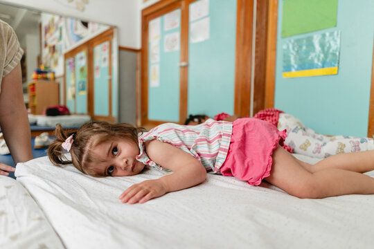Toddler girl resting during nap time in daycare center
