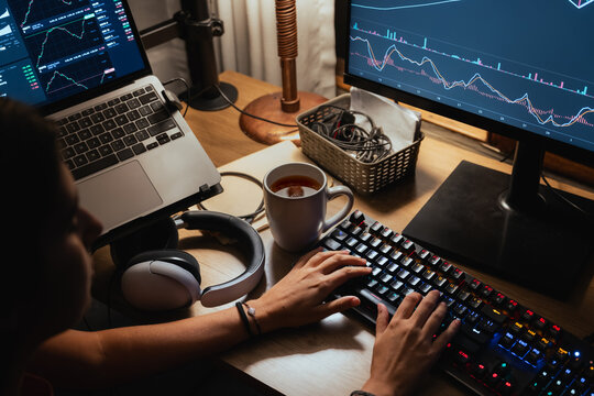 woman Trading Stock on Multiple Screens at Home office setup