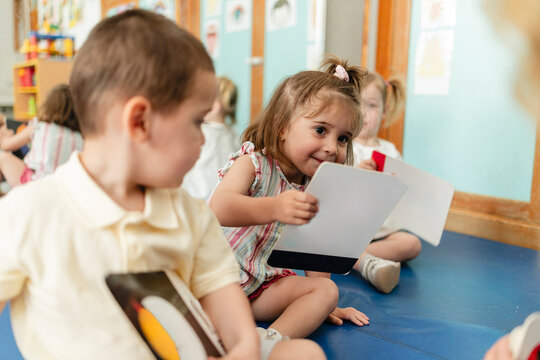 Little children playing and learning together in kindergarten