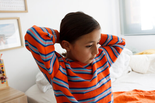 Girl Styles Hair in Bright Room 