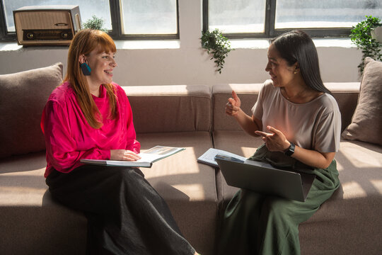 Two Female Colleagues Having a Friendly Business Meeting 