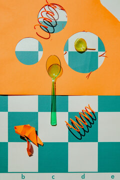 Creative arrangement of colorful objects on a checkered surface