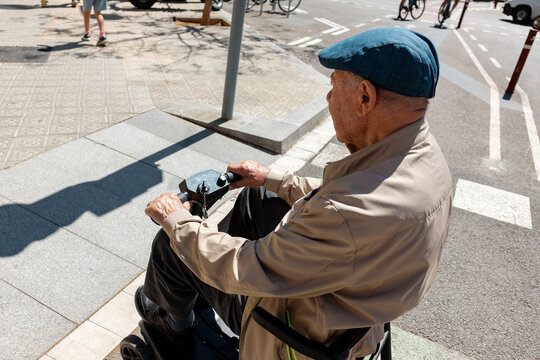 Senior Man on mobility Scooter on city. 