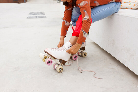 Skate Roller Girl Ties Her Skates in the Park 
