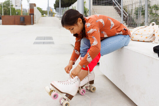 Girl Ties Skates  at Urban Skate Park