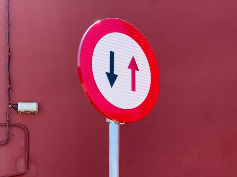 Traffic Sign Mounted Against Red Building