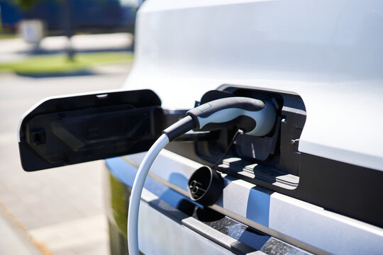 Electric vehicle charging at public station, green energy future