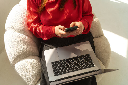Anonymous Remote Work Professional Using Phone and Laptop 