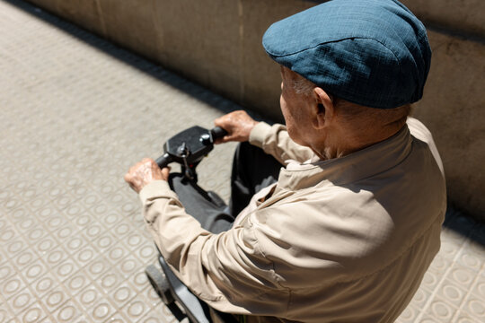 Senior Man on mobility Scooter on city. 