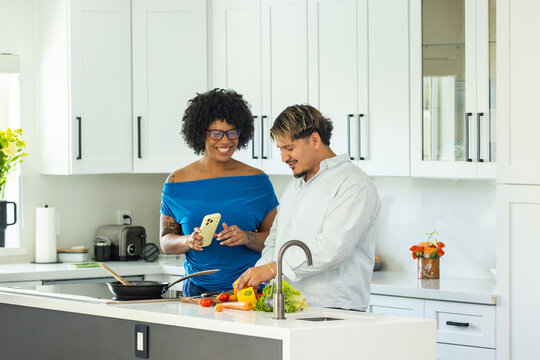 Home Young couple chat  in Kitchen prepare meal 