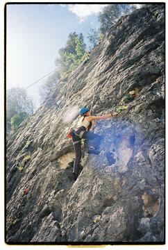 Female rock climbing outdoors