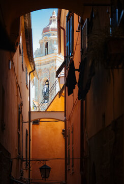 Narrow street view with church tower in the background