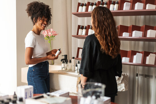 Smiling Saleswoman Consultation In Skincare Boutique with Customer