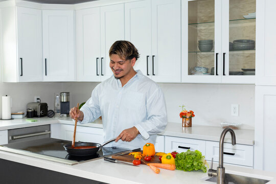 Hispanic man  preparing sauce   at home 