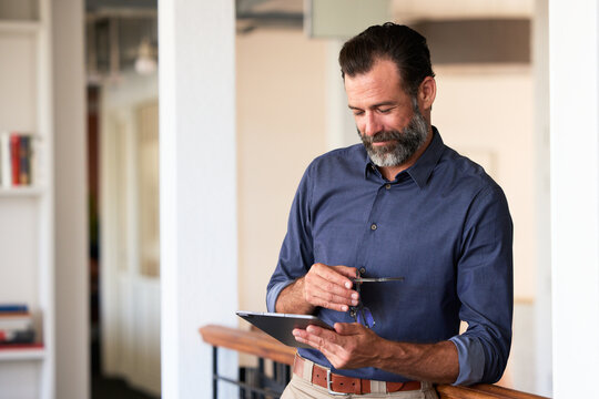 Businessman Standing With Tablet