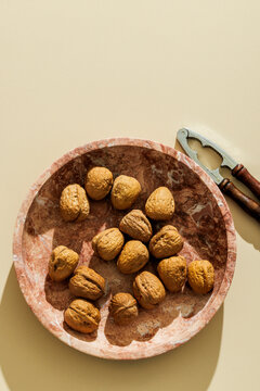Walnuts on a plain beige surface