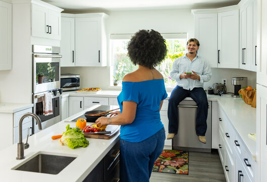 Young couple chat  in Kitchen prepare meal 