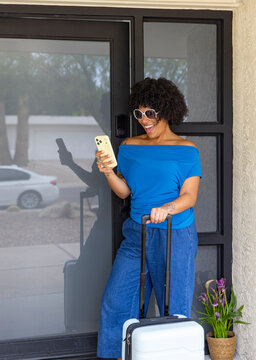 Black woman  Portrait home wait  rideshare app  cell phone 