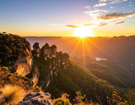 The Three Sisters rock formation glows under the golden sunrise in the Blue Mountains.