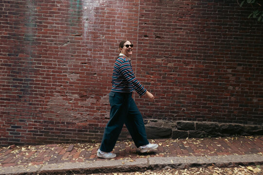 Stylish Smiling woman walking on the streets