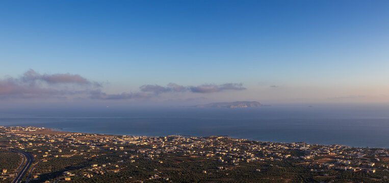 High angle panoramic view of Kato Gouves coastal town and Dia island in the Mediterranean sea, shot from Mount Edheri in Crete, Greece during early morning