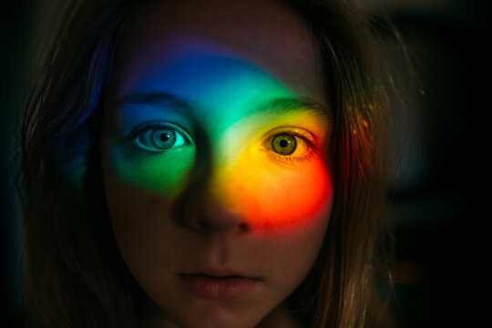 Portrait of a little girl with rainbow on face