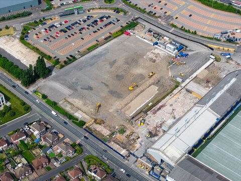 Leeds UK, 19th June 2026: Aerial view of redevelopment land beside Elland Road football stadium in Leeds showing demolition works construction machinery cleared ground parking facilities
