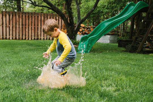 Boy Splashing in Puddle