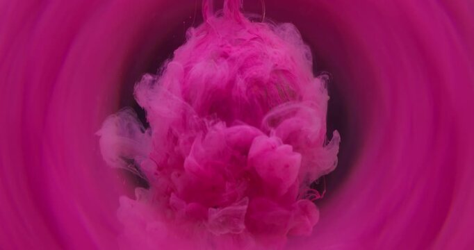 Ink shot. Mist paint. Brown pink pigment dripping color water blur vapor splash. Dye blob on glass crystal drop abstract round frame black background.