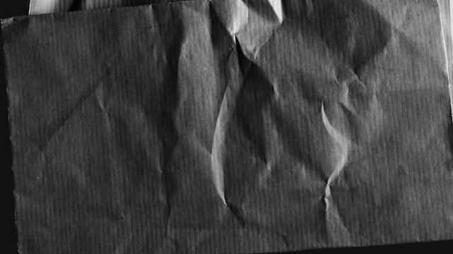 Abstract crumpled paper texture in monochrome black and white