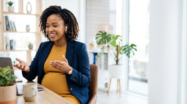 Smiling pregnant black businesswoman talking on video call in office, remote presentation, diverse employee, legal maternity rights at work