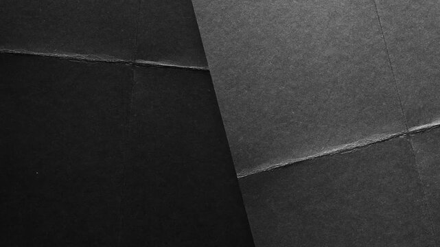 Minimalist black paper texture background, with geometric fold lines