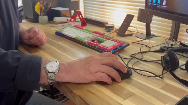 Hand using computer mouse at desk