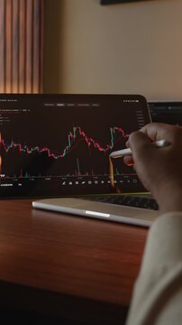 Trader Analysing Stock Market Charts on an iPad through a brokerage platform.