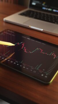 Trader Analysing Stock Market Charts on an iPad through a brokerage platform.