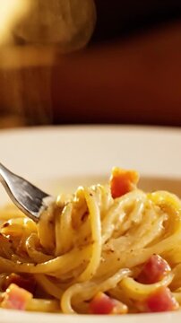 Macro 360 Degree Rotating View Of Creamy Carbonara Pasta Swirling On A Fork With Pancetta Bits And Black Pepper Dusting