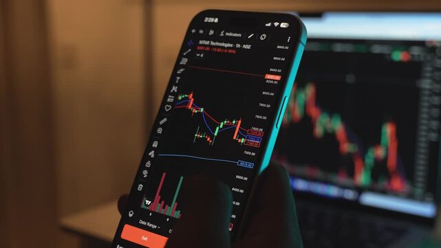 Trader Analyzing Stock Market Charts on Smartphone Through Brokerage App