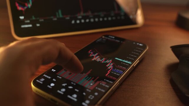 Trader Analyzing Stock Market Charts on Smartphone Through Brokerage App