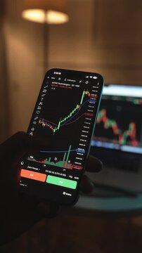 Trader Analyzing Stock Market Charts on Smartphone Through Brokerage App