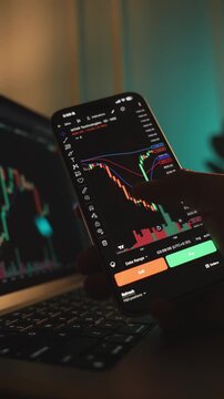 Trader Analyzing Stock Market Charts on Smartphone Through Brokerage App