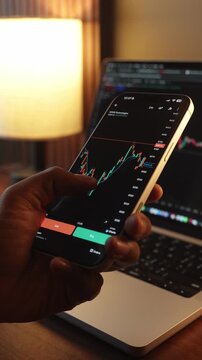 Trader Analyzing Stock Market Charts on Smartphone Through Brokerage App