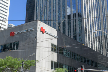 Fototapeta premium corner perspective view of sign on the exterior of Roserock Place, for National Bank, a financial institution, located at 121 King St W, southeast corner at York St, Toronto