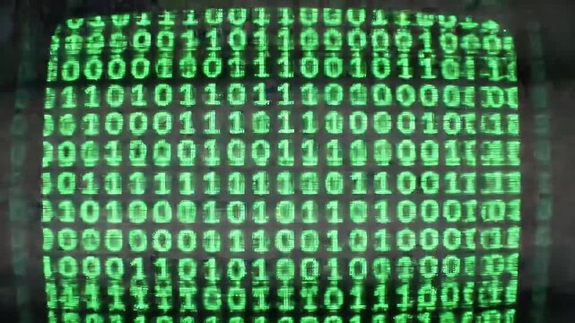 Green binary code displayed on a retro computer screen.